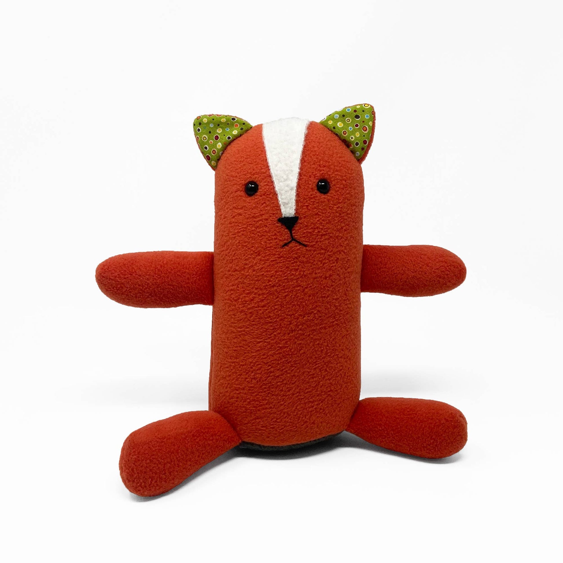 Stuffed toy fox with green ears on a white background